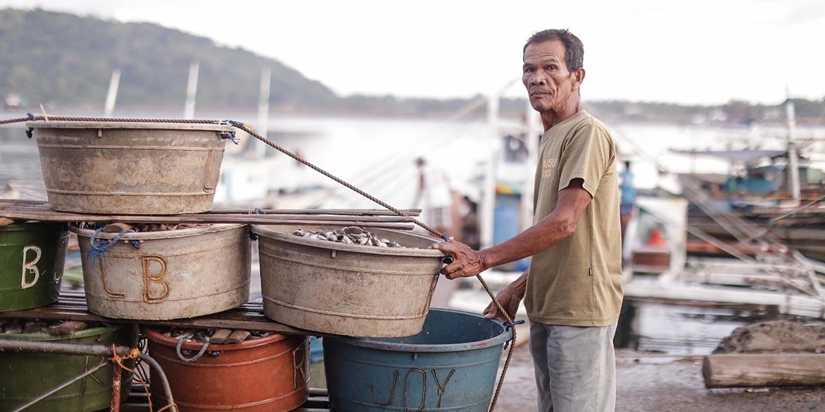 A local fisher preparing to sell sustainably caught fish on a new, online marketplace.