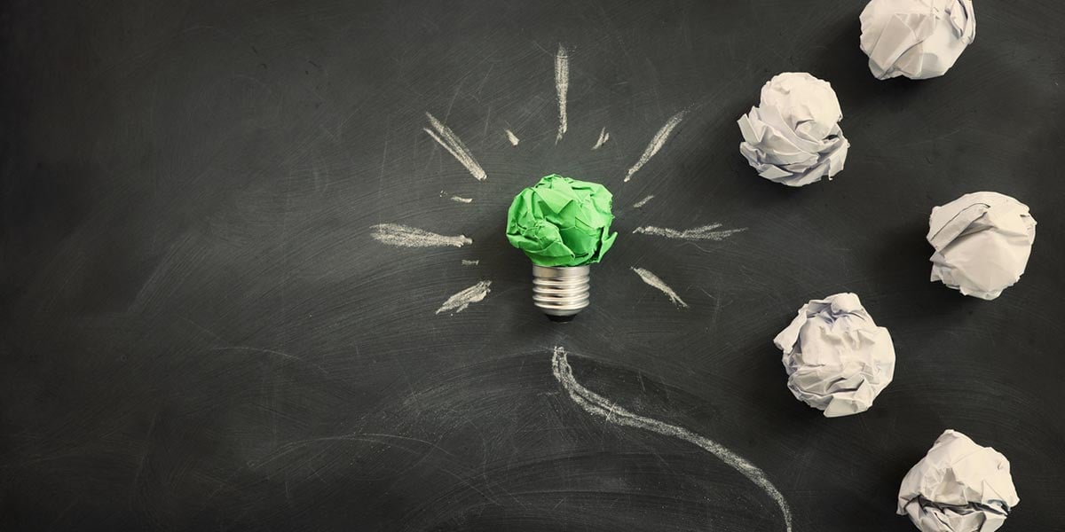 Concept of green crumpled paper lightbulb to highlight necessary factors for leading sustainable companies. 