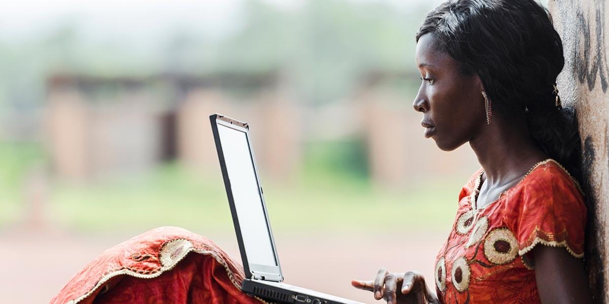 Person on laptop working on a sustainable business model for digital innovation. 